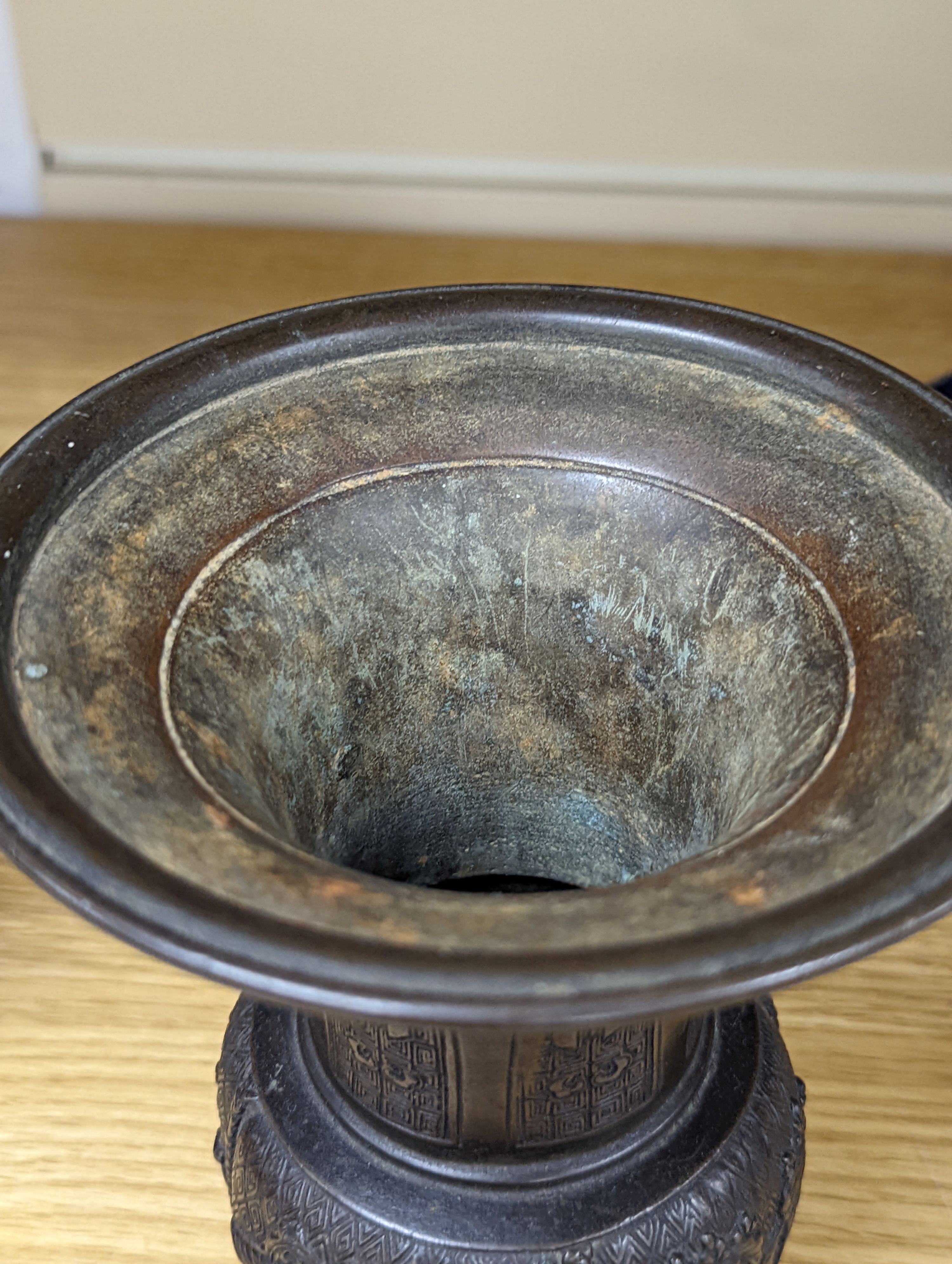 A pair of Japanese Meiji period bronze ‘dragon’ bottle vases and another, 21cm